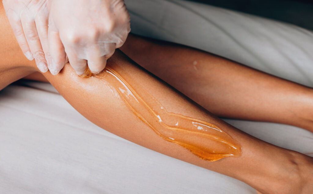 Close upper view photo of a sugaring procedure at the spa salon